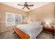 Serene bedroom with neutral walls, a ceiling fan, plantation shutters, and side tables providing comfort and style at 14819 W Lupine Ln, Surprise, AZ 85374