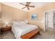 Bright bedroom with neutral walls, ceiling fan, plantation shutters, and warm wooden accents offering a comfortable escape at 14819 W Lupine Ln, Surprise, AZ 85374