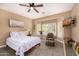 Inviting bedroom with a cozy armchair, bay windows with shutters, and a ceiling fan offering a serene retreat at 14819 W Lupine Ln, Surprise, AZ 85374