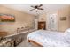 Relaxing bedroom with a decorative console table, bay windows with shutters, and neutral walls for a peaceful ambiance at 14819 W Lupine Ln, Surprise, AZ 85374