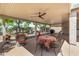 Covered patio with outdoor seating and dining area, complemented by ceiling fan and backyard views at 14819 W Lupine Ln, Surprise, AZ 85374