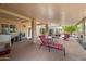 Covered patio with seating, ceiling fan, and views of the landscaped backyard at 14819 W Lupine Ln, Surprise, AZ 85374