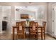 The dining room has a wood table and a view into the living room at 14819 W Lupine Ln, Surprise, AZ 85374