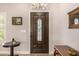 Elegant front door with decorative glass inserts and detailed wood trim at 14819 W Lupine Ln, Surprise, AZ 85374