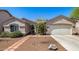 Charming single-story home with well-maintained landscaping and a two-car garage at 14819 W Lupine Ln, Surprise, AZ 85374