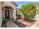 Charming front entry with a decorative front door and manicured landscaping at 14819 W Lupine Ln, Surprise, AZ 85374