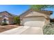 Side view of home showing attached garage and low maintenance front yard at 14819 W Lupine Ln, Surprise, AZ 85374