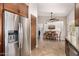 Open kitchen view with stainless steel refrigerator and adjacent dining area at 14819 W Lupine Ln, Surprise, AZ 85374