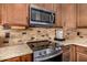 A gourmet kitchen featuring stainless steel appliances and granite countertops, perfect for culinary enthusiasts at 14819 W Lupine Ln, Surprise, AZ 85374