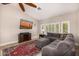 Bright living room boasts a sectional sofa, media cabinet and large windows at 14819 W Lupine Ln, Surprise, AZ 85374