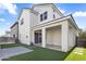The backyard features artificial grass, a covered patio, and direct access to the home's interior at 15718 W Polk St, Goodyear, AZ 85338