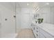 Bright bathroom with double sink vanity, quartz countertops and walk in shower at 15718 W Polk St, Goodyear, AZ 85338