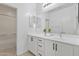 Bright bathroom featuring a vanity with white cabinets and drawers and a large mirror at 15718 W Polk St, Goodyear, AZ 85338