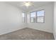Bedroom featuring neutral carpet, a ceiling fan, and two large windows at 15718 W Polk St, Goodyear, AZ 85338