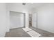 Carpeted bedroom with an open closet space and access to the bathroom at 15718 W Polk St, Goodyear, AZ 85338