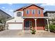 Charming two-story home featuring a welcoming porch and an attached two-car garage at 15718 W Polk St, Goodyear, AZ 85338