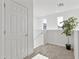 Hallway featuring carpeted floors and staircase at 15718 W Polk St, Goodyear, AZ 85338