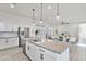 Bright, white kitchen with granite countertops and stainless steel appliances at 15718 W Polk St, Goodyear, AZ 85338