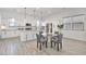 Bright, white kitchen featuring a large island, stainless steel appliances, and adjacent dining area at 15718 W Polk St, Goodyear, AZ 85338