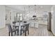 Bright, white kitchen with a glass top dining table and stainless steel appliances at 15718 W Polk St, Goodyear, AZ 85338