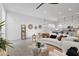 Bright living room showcasing white furniture and open layout to the kitchen at 15718 W Polk St, Goodyear, AZ 85338