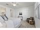 Bright main bedroom with chair, large bed and ceiling fan at 15718 W Polk St, Goodyear, AZ 85338