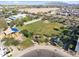 Aerial view of a neighborhood park featuring green space, a playground, and a shaded picnic area at 15718 W Polk St, Goodyear, AZ 85338