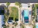 Aerial view of the community pool surrounded by lounge chairs and green spaces for relaxing at 15718 W Polk St, Goodyear, AZ 85338