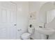 Bright powder room featuring pedestal sink and stylish decor at 15718 W Polk St, Goodyear, AZ 85338