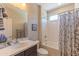 Functional bathroom featuring a single sink vanity, toilet, and a shower-tub combo with a curtain at 16417 W Piccadilly Rd, Goodyear, AZ 85395