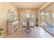 Elegant dining room with a chandelier, stylish furnishings, and sliding glass doors to the outdoor patio at 16417 W Piccadilly Rd, Goodyear, AZ 85395