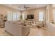 Cozy living room featuring plantation shutters, tile floors, and comfortable seating, ideal for relaxation at 16417 W Piccadilly Rd, Goodyear, AZ 85395