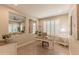 Bright home office with natural light, wood floors, and a view into the living room at 16417 W Piccadilly Rd, Goodyear, AZ 85395