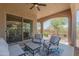 Covered patio with comfortable seating and a ceiling fan, perfect for outdoor relaxation and entertaining at 16417 W Piccadilly Rd, Goodyear, AZ 85395