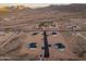 Areal view of homes in a desert landscape neighborhood with mountain views in the distance at 16627 N Slate Ln, Maricopa, AZ 85139