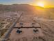 Aerial view showcasing multiple homes and mountain views during sunset at 16627 N Slate Ln, Maricopa, AZ 85139