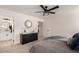 Relaxing bedroom featuring carpet floors, windows for natural light, ceiling fan, and attached bath at 16627 N Slate Ln, Maricopa, AZ 85139