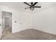 Bedroom featuring carpet floors, a ceiling fan, and a closet with sliding doors at 16627 N Slate Ln, Maricopa, AZ 85139