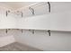 Spacious walk-in closet with wood shelving and carpet flooring at 16627 N Slate Ln, Maricopa, AZ 85139