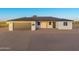 Charming single-story home featuring a gray garage door and a well-maintained desert landscape at 16627 N Slate Ln, Maricopa, AZ 85139