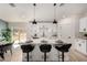 Well-lit kitchen features a large island with bar stools, and sleek modern appliances at 16627 N Slate Ln, Maricopa, AZ 85139