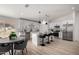 Bright kitchen with white cabinetry, stainless steel appliances, and a spacious island with seating at 16627 N Slate Ln, Maricopa, AZ 85139