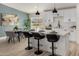 Modern kitchen with white cabinets, an island with bar stools, and stainless steel appliances at 16627 N Slate Ln, Maricopa, AZ 85139