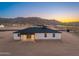 This home features a covered patio, an open backyard, and beautiful mountain views at 16627 N Slate Ln, Maricopa, AZ 85139
