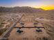 An aerial view captures homes in a desert landscape, with mountain backdrop at 16630 N Slate Ln, Maricopa, AZ 85139