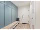 Welcoming mudroom area with a built-in bench, storage, and stylish wood-look flooring at 16630 N Slate Ln, Maricopa, AZ 85139