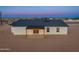 Home with a covered patio, desert landscape, and mountain views at sunset at 16630 N Slate Ln, Maricopa, AZ 85139