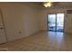 Bright bedroom with tile floors and sliding glass doors leading to the patio at 17056 N 107Th Ave, Sun City, AZ 85373