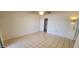 Bedroom with neutral tile flooring, white walls, closet, and a ceiling fan at 17056 N 107Th Ave, Sun City, AZ 85373