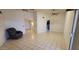Open-plan living room with tile flooring, ceiling fan, and access to the kitchen and entry at 17056 N 107Th Ave, Sun City, AZ 85373